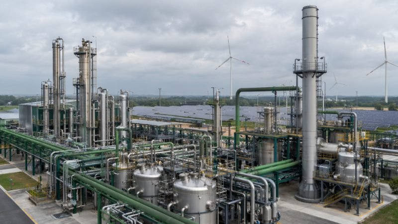 Industrial chemical plant producing bio-based silane coupling agents with green energy infrastructure visible